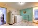 Bright laundry room with full-size washer and dryer, and a convenient drying rack at 1220 10Th Sw St, Largo, FL 33770