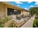 Cozy front patio with chairs offering a relaxing outdoor space, complemented by tropical landscaping at 1301 Eniswood Pkwy, Palm Harbor, FL 34683