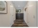 Hallway features dark wood floors, updated light fixtures, a mirror, and a plant at 1301 Eniswood Pkwy, Palm Harbor, FL 34683