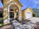 Front entryway with archway, double doors, and a walkway at 1334 Windsor Way, Lutz, FL 33559