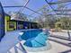 Inviting kidney-shaped pool with a screened enclosure and spa at 1334 Windsor Way, Lutz, FL 33559