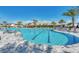 Resort-style pool with lounge chairs and palm trees at 16111 Fortezza Dr, Bradenton, FL 34211