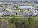 Aerial view of neighborhood with lake and houses at 16732 Mooner Plank Cir, Wimauma, FL 33598