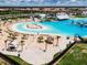Expansive lagoon pool with beach entry and lounge area at 16732 Mooner Plank Cir, Wimauma, FL 33598
