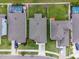 Aerial view of houses with grey roofs and green lawns at 16732 Mooner Plank Cir, Wimauma, FL 33598