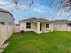 Home exterior with covered patio and fenced backyard at 16732 Mooner Plank Cir, Wimauma, FL 33598