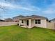 Charming home with a spacious backyard, covered patio, and fenced yard at 16732 Mooner Plank Cir, Wimauma, FL 33598