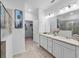 Double vanity bathroom with a shower and walk-in closet at 16732 Mooner Plank Cir, Wimauma, FL 33598