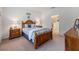 Cozy bedroom with wooden bed frame, nightstands, and an ensuite bathroom at 16732 Mooner Plank Cir, Wimauma, FL 33598