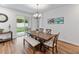 Bright dining room with wooden table, bench, and access to backyard at 16732 Mooner Plank Cir, Wimauma, FL 33598