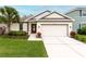 Attractive one-story home with a two-car garage and manicured lawn at 16732 Mooner Plank Cir, Wimauma, FL 33598