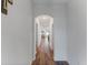 Spacious hallway with hardwood floors leading to the main living areas at 16732 Mooner Plank Cir, Wimauma, FL 33598