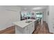 Open concept kitchen with island and stainless steel appliances at 16732 Mooner Plank Cir, Wimauma, FL 33598