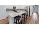 Modern kitchen with white cabinets, stainless steel appliances, and an island at 16732 Mooner Plank Cir, Wimauma, FL 33598