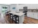 Modern kitchen with white cabinets, stainless steel appliances, and a large island at 16732 Mooner Plank Cir, Wimauma, FL 33598