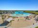 Large lagoon pool with beach area and water features at 16732 Mooner Plank Cir, Wimauma, FL 33598