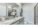 Bathroom with granite countertops, double sinks, and a walk-in shower at 18134 Cropside Trl, Lakewood Ranch, FL 34211