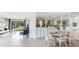 Bright dining area with white table and chairs, view into living room at 18134 Cropside Trl, Lakewood Ranch, FL 34211