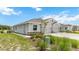 Single-story house with gray siding, two-car garage, and landscaping at 18134 Cropside Trl, Lakewood Ranch, FL 34211