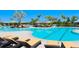 Relaxing resort-style pool with ample lounge chairs and umbrellas at 18137 Cropside Trl, Lakewood Ranch, FL 34211