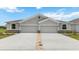 Two-story home with a two-car garage and light gray exterior at 18138 Cropside Trl, Lakewood Ranch, FL 34211