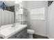 Clean bathroom with gray vanity, toilet and shower at 206 N Himes Ave, Tampa, FL 33609