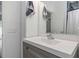 Gray vanity with white sink and a mirror in the bathroom at 206 N Himes Ave, Tampa, FL 33609
