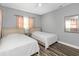 Bedroom with two twin beds, gray walls and pink curtains at 206 N Himes Ave, Tampa, FL 33609