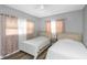 Bedroom with two twin beds, gray walls and pink curtains at 206 N Himes Ave, Tampa, FL 33609