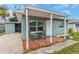 Cute teal home with covered patio and a charming entryway at 206 N Himes Ave, Tampa, FL 33609