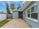 Side view of teal home showcasing additional patio space at 206 N Himes Ave, Tampa, FL 33609