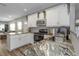 Modern kitchen with granite countertops and white cabinets at 206 N Himes Ave, Tampa, FL 33609