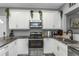 Modern kitchen with white cabinets and granite countertops at 206 N Himes Ave, Tampa, FL 33609