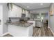 Modern kitchen with white cabinets, granite counters, and stainless steel appliances at 206 N Himes Ave, Tampa, FL 33609