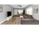 Living room with sectional sofa, large TV, and hardwood floors at 206 N Himes Ave, Tampa, FL 33609