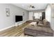 Living room with sectional sofa, large TV, and hardwood floors at 206 N Himes Ave, Tampa, FL 33609