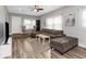 Living room with sectional sofa, large TV, and hardwood floors at 206 N Himes Ave, Tampa, FL 33609