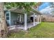 Covered patio with seating area and grill at 206 N Himes Ave, Tampa, FL 33609