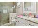 White bathroom with granite countertop and walk-in shower at 2315 Dovewood Estates Ct, Valrico, FL 33594