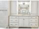 Elegant bathroom with white cabinets, granite countertop, and large mirror at 2315 Dovewood Estates Ct, Valrico, FL 33594