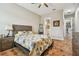 Comfortable bedroom with wood floors and floral bedding at 2315 Dovewood Estates Ct, Valrico, FL 33594