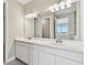 Bathroom with double vanity, modern fixtures and neutral colors at 2416 Wise River Ln, Zephyrhills, FL 33541