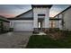 Modern two-story home with gray siding and stone accents at 2416 Wise River Ln, Zephyrhills, FL 33541