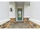 Green front door with glass inserts and stone entryway at 2416 Wise River Ln, Zephyrhills, FL 33541