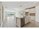 Modern kitchen with an island that overlooks the living room at 2416 Wise River Ln, Zephyrhills, FL 33541