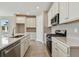 Modern kitchen with white cabinets and stainless steel appliances at 2416 Wise River Ln, Zephyrhills, FL 33541