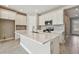 Modern kitchen with white cabinets, island, and stainless steel appliances at 2416 Wise River Ln, Zephyrhills, FL 33541