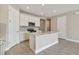 Modern kitchen with white cabinets, island, and stainless steel appliances at 2416 Wise River Ln, Zephyrhills, FL 33541