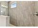 Modern shower with neutral tile and a window for natural light at 2416 Wise River Ln, Zephyrhills, FL 33541