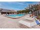 Community pool with lounge chairs and solar panels at 2561 Royal Pines Cir # 14H, Clearwater, FL 33763